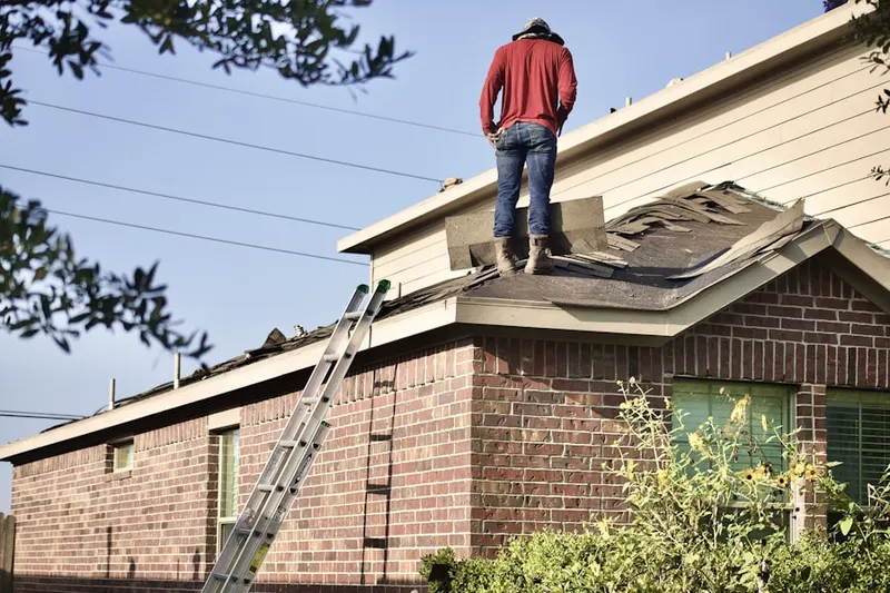 Professional roofer working on a residential roof in Mound City